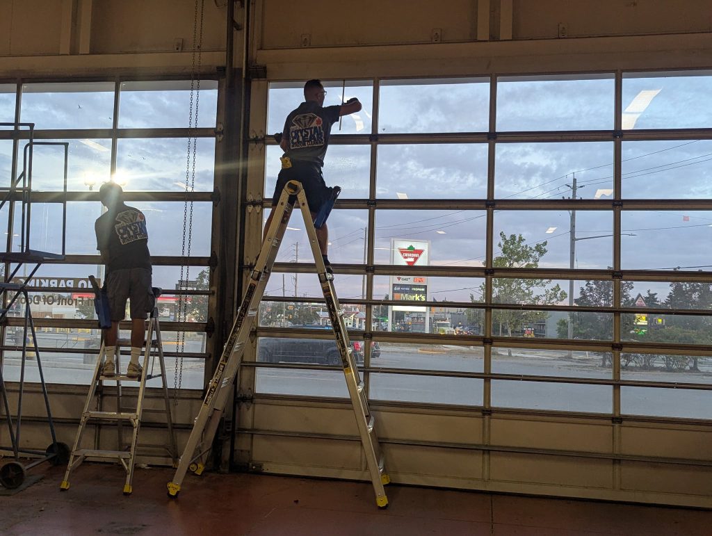 Cleaning interior windows at local London Ontario vehicle service shop